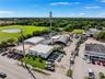 Industrial property featuring multiple structures, paved exterior surface area, and established perimeter landscaping