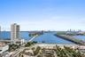 Expansive cityscape featuring open water, multi-lane bridge infrastructure, and high-rise architecture