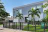 Modern two-story exterior featuring multi-tonal gray stucco finish, clean-lined horizontal metal fencing, a paved front walkway, and an attached singl
