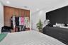 Floor-to-ceiling wood-finish built-in cabinetry featuring sliding doors and recessed ceiling lighting