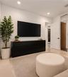 Recessed lighting, smooth-finish neutral walls, polished tile flooring, and solid-core interior doors with matte black hardware