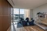 Floor-to-ceiling glass windows, wood-finish flooring, custom wood-slat wall paneling, built-in wall shelving, and an integrated balcony