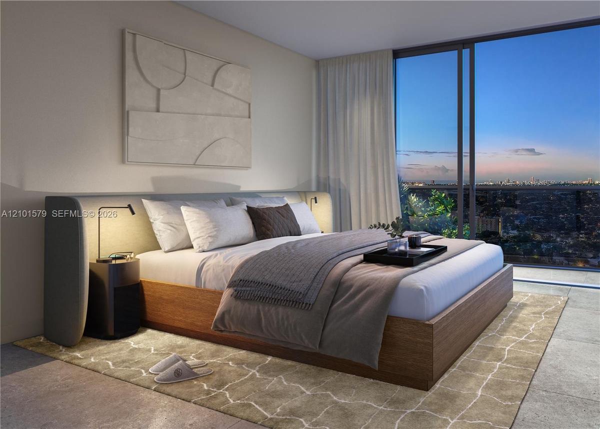 Floor-to-ceiling windows, neutral interior wall palette, stone-finish flooring, and recessed architectural lighting