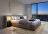 Floor-to-ceiling windows, neutral interior wall palette, stone-finish flooring, and recessed architectural lighting