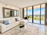 Floor-to-ceiling sliding glass doors, private balcony, polished tile flooring, and recessed ceiling lighting