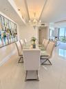 Dining area featuring polished large-format tile flooring, a decorative tiered chandelier, recessed accent lighting, and a recessed ceiling design