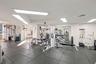 Fitness facility featuring rubberized flooring and recessed rectangular lighting panels