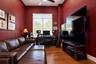 Room featuring high ceilings, wood-finish flooring, a large window with horizontal blinds, and a ceiling fan with integrated lighting