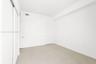 Neutral white wall finishes, light-toned tile flooring, recessed ceiling lighting, and sliding closet doors