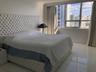 Large-format tile flooring, floor-to-ceiling windows, and urban cityscape backdrop