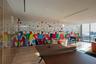 Floor-to-ceiling glass wall, wood-finish flooring, recessed lighting, and expansive window wall with external scenery