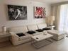 Neutral-toned tile flooring, white walls, and floor-to-ceiling drapery