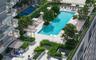 Rectangular swimming pool surrounded by a paved sun deck, dedicated pickleball court, integrated landscaping planters, and covered pergola structures