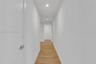 Hallway featuring wood-finish flooring, recessed lighting, and interior doors with brushed metal lever hardware