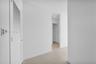 Louvered door, neutral tile flooring, recessed lighting, and crisp white walls