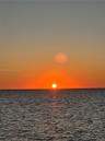 Ocean horizon featuring a prominent sunset backdrop