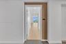Entryway featuring wood-finish paneling, white interior door, recessed lighting, and wood-finish flooring