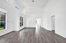 Interior space with high ceilings, wood-finish flooring, and expansive windows providing natural light