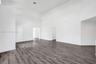 Vaulted ceilings, expansive open-concept interior, and dark wood-finish flooring