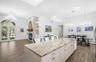 Cool island, formal dining overlooks golf course with a lake view.