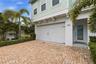 Two car garage with paver driveway for additional parking