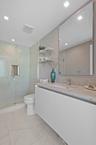 Guest bedroom 1 features more designer touches, automated shades & blinds, customized closet, and ensuite bathroom.