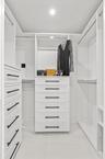 Fully customized cabinetry adorn the his & hers closets providing maximum storage and function.