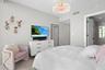 Guest bedroom 1 features more designer touches, automated shades & blinds, customized closet, and ensuite bathroom.