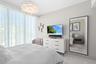 Guest bedroom 1 features more designer touches, automated shades & blinds, customized closet, and ensuite bathroom.