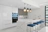 Culinary enthusiasts will enjoy a true chef's kitchen, highlighted with custom Italian cabinetry, Quartz countertops, and luxury (SubZero & Miele) app