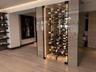 Floor-to-ceiling glass enclosed wine display featuring integrated LED accent lighting, wood-finish wall paneling, and custom horizontal bottle racking