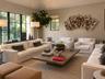 Vaulted ceilings, large-format black-frame windows, recessed lighting, and textured wall coverings