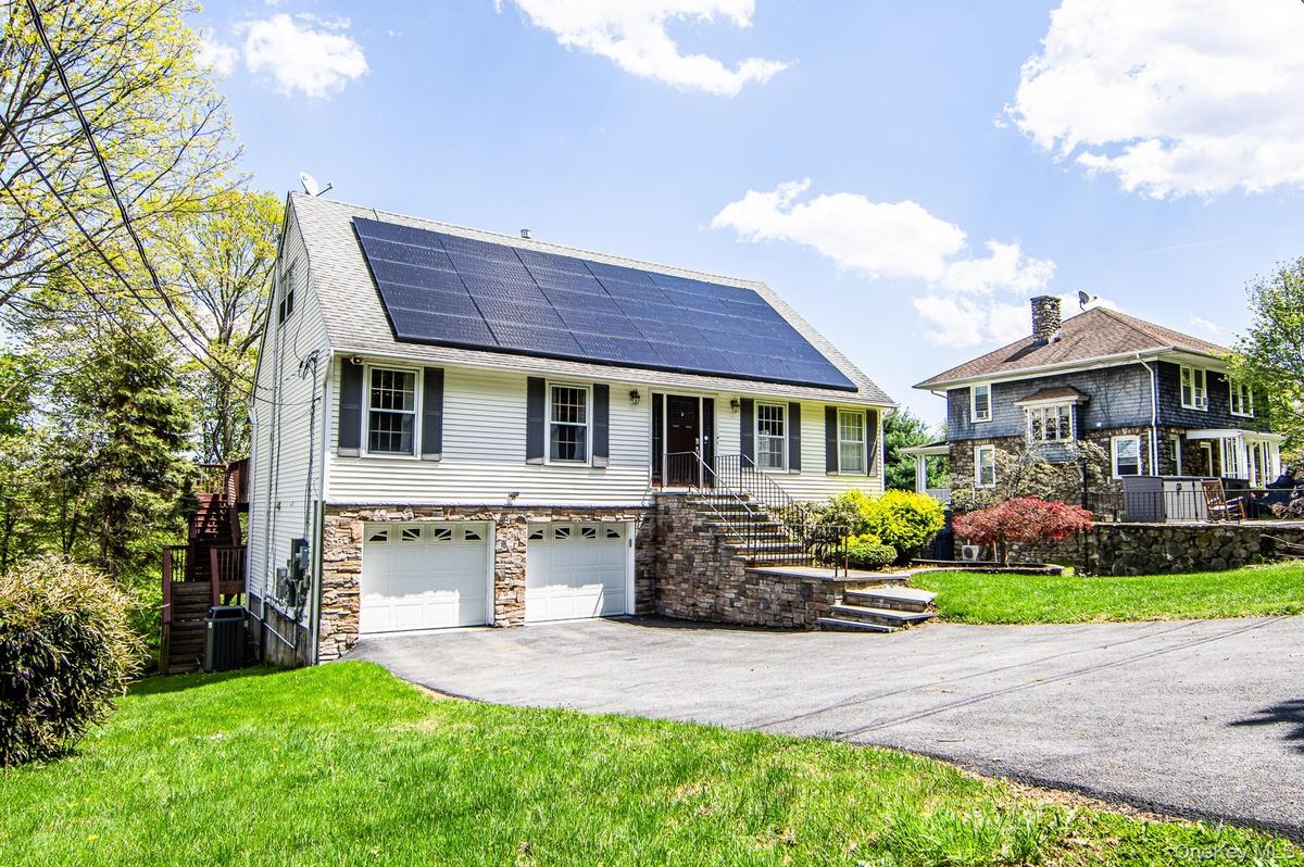 Welcome Home to this Contemporary cape with vinyl and stone front