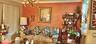 Living area featuring crown molding, textured accent wall, and multi-arm chandelier
