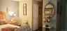 Six-panel interior door with brass-finish hardware and neutral-tone wall finishes
