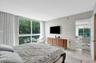 Floor-to-ceiling windows, polished stone flooring, and neutral wall tones