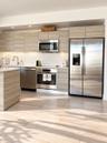Kitchen featuring horizontal-grain wood-finish cabinetry, stainless steel appliances, solid-surface countertops, recessed ceiling lighting, and wood-f