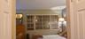 Room featuring multi-pane window with vertical blinds and dual-panel interior doorway