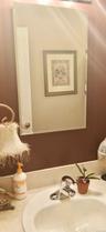 Frameless rectangular wall mirror paired with a polished chrome single-handle faucet and integrated sink basin