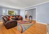 Hardwood flooring, crown molding, wide baseboards, light blue wall paint, and white trim