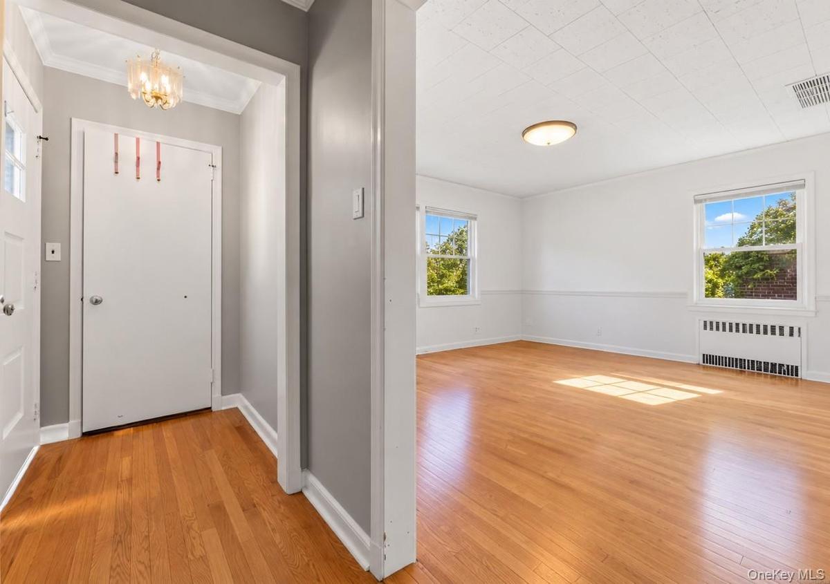 Welcoming sunlit entry foyer to Dining Area and Living Room