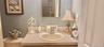 Wall-mounted mirror, vanity featuring a solid-surface countertop with an integrated basin, and single-handle chrome faucet