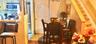 Wood-finish flooring, stainless steel kitchen appliances, dual-panel closet doors, and hardwood staircase with matching handrail