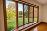 Bow window overlooking front yard and private stocked pond