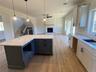 Construction progress photo showcasing the openkitchen layout creates seamless connection tosurrounding living spaces.