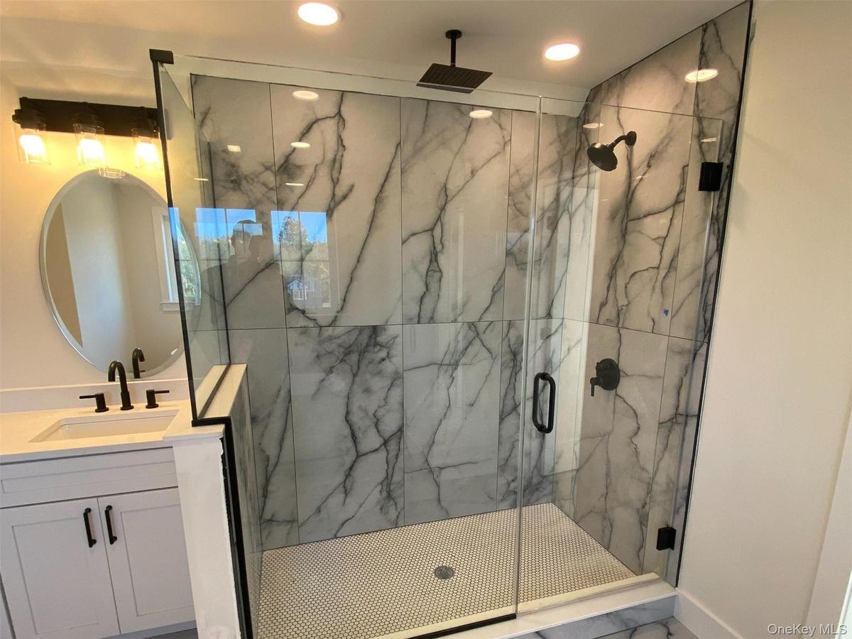 Alternate view of the spacious, glass enclosed walk in shower designed for a polished look and easy maintenance.