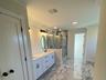 The primary ensuite bath is nearing completion with luxurious tile and coordinating fixtures.