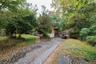 Entrance Driveway leading to two car Garage and side of home - Driveway allows for ample parking