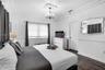 Room featuring crown molding, chair rail trim, wood-finish flooring, a decorative ceiling medallion, and a multi-arm chandelier