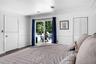 Interior space featuring crown molding, wainscoting, wood-finish flooring, and sliding glass doors with direct access to an outdoor area